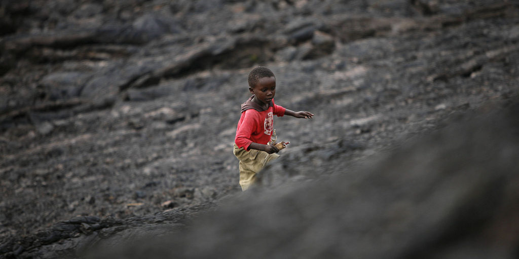 Child walking on lava from the last Nyiragongo eruption in 2002