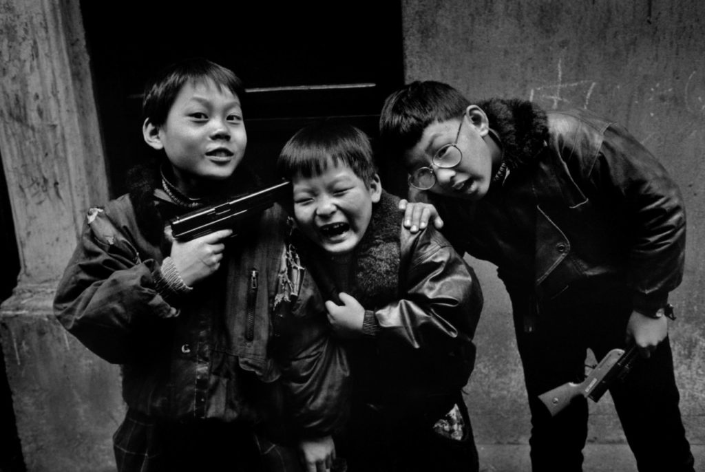Children play with gun in Shanghai, China, 1995