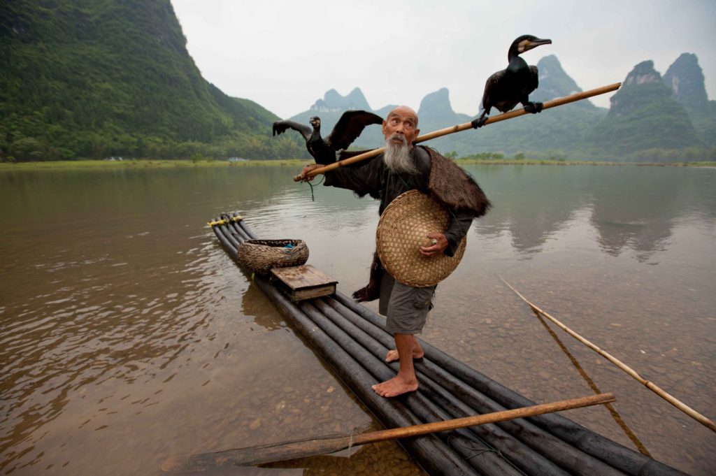 Old man on Li River, China
