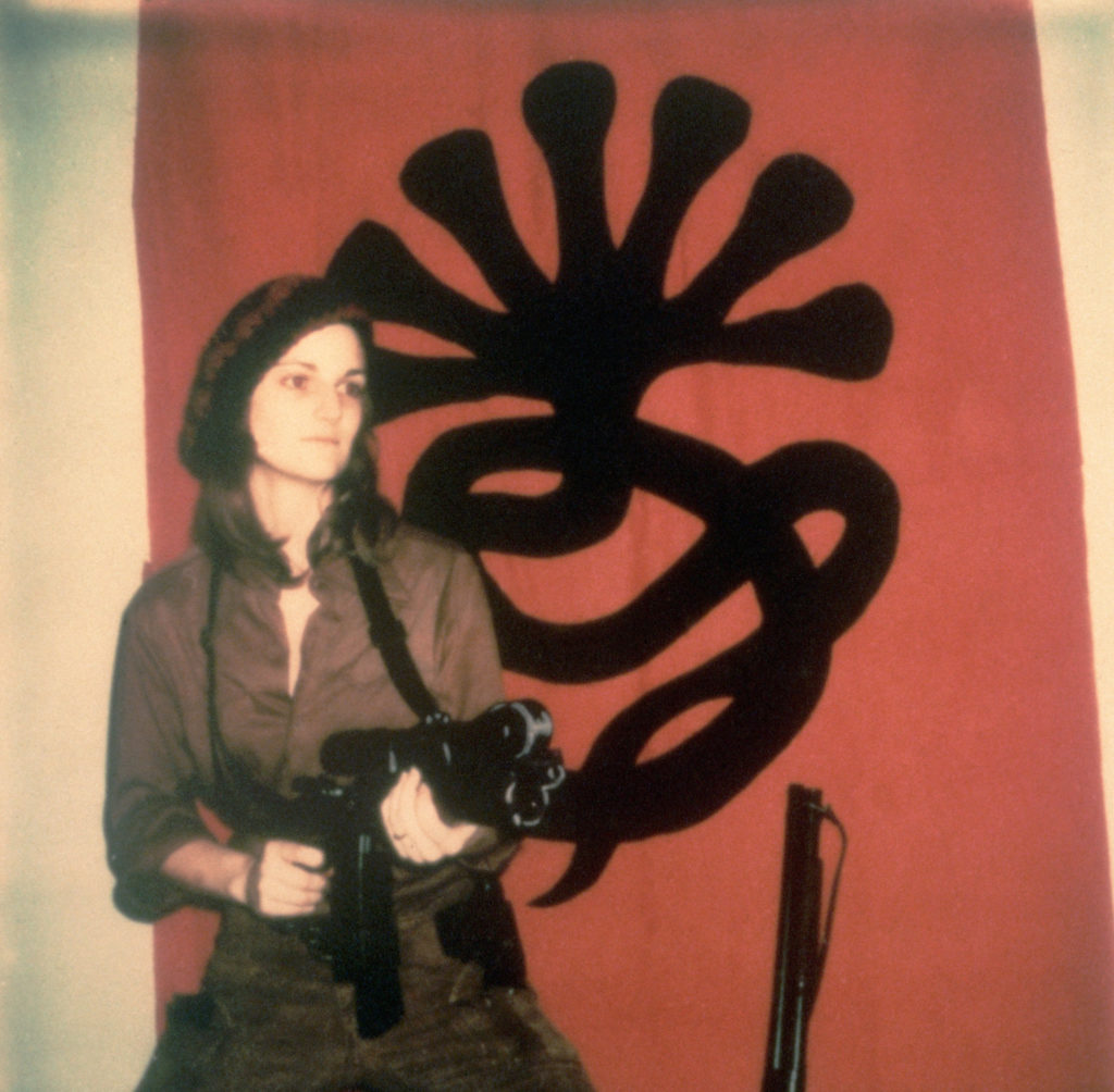 Patty Hearst, armed and impassive